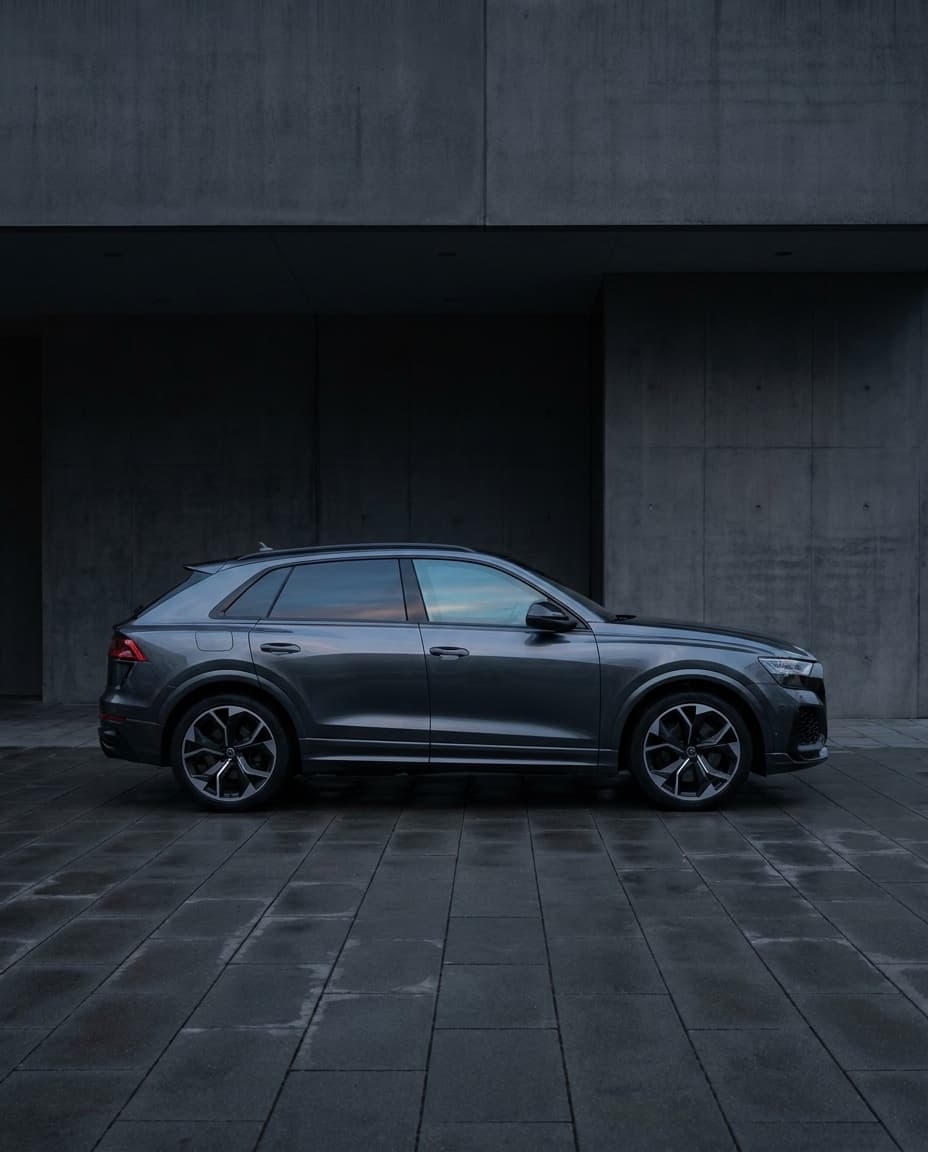 Automotive gallery image showing a generic tinted performance SUV in a clean side profile