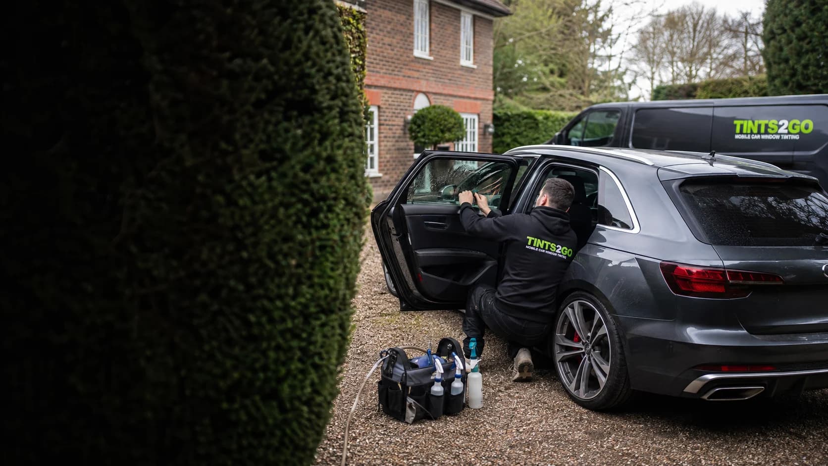 Illustrative UK driveway appointment with a Tints2Go van