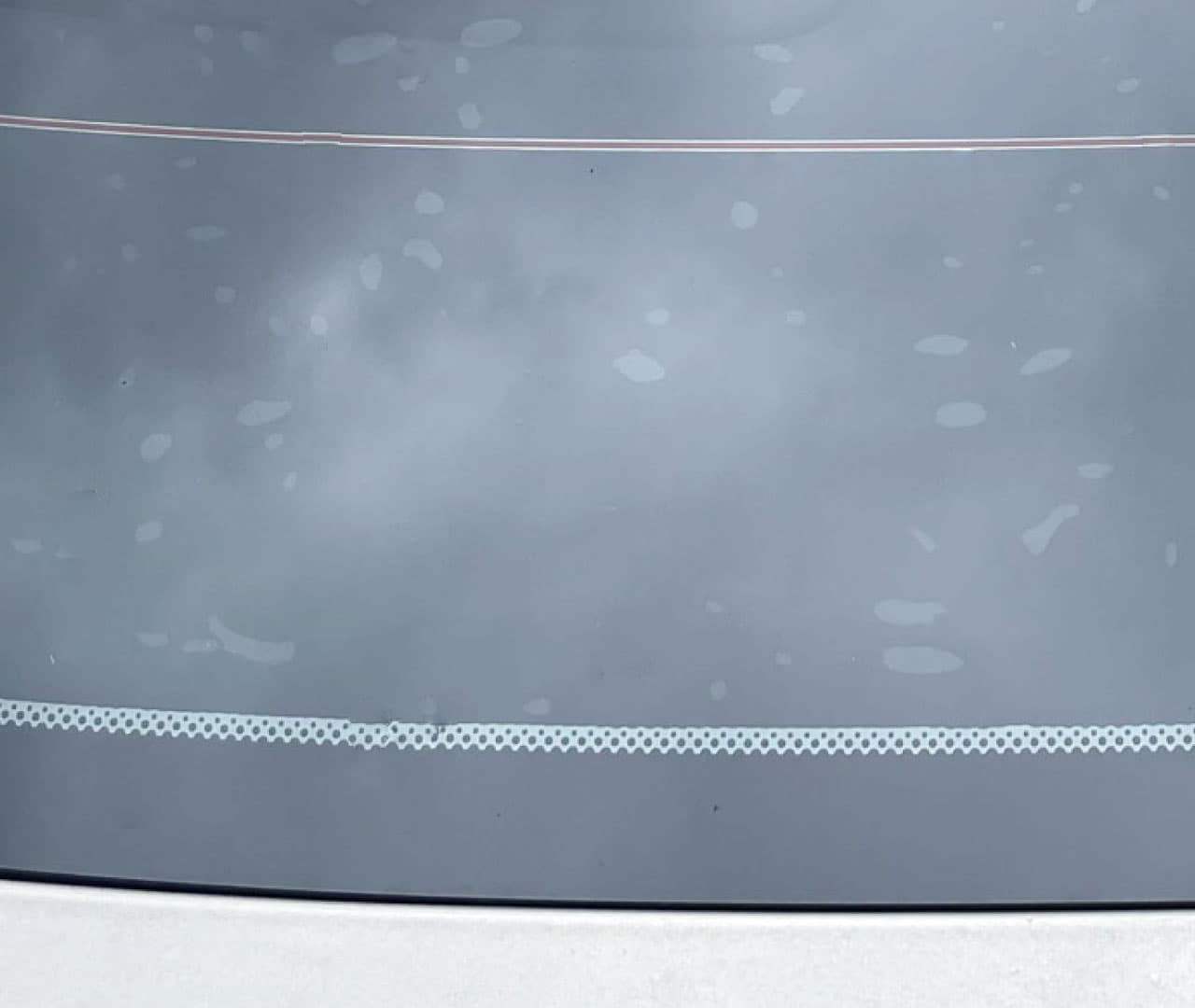 Water bubbles visible while automotive window film is drying.